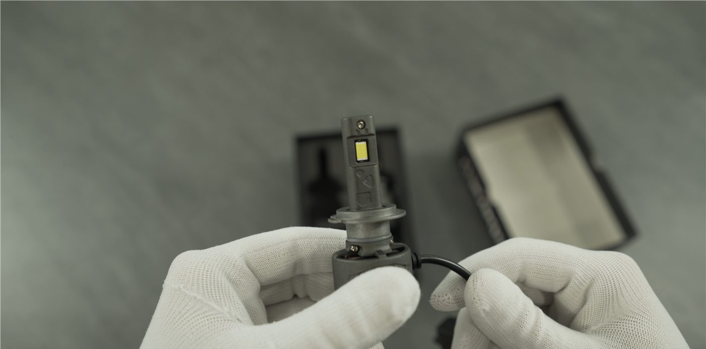 Close-up of an LED headlight bulb being inspected during testing